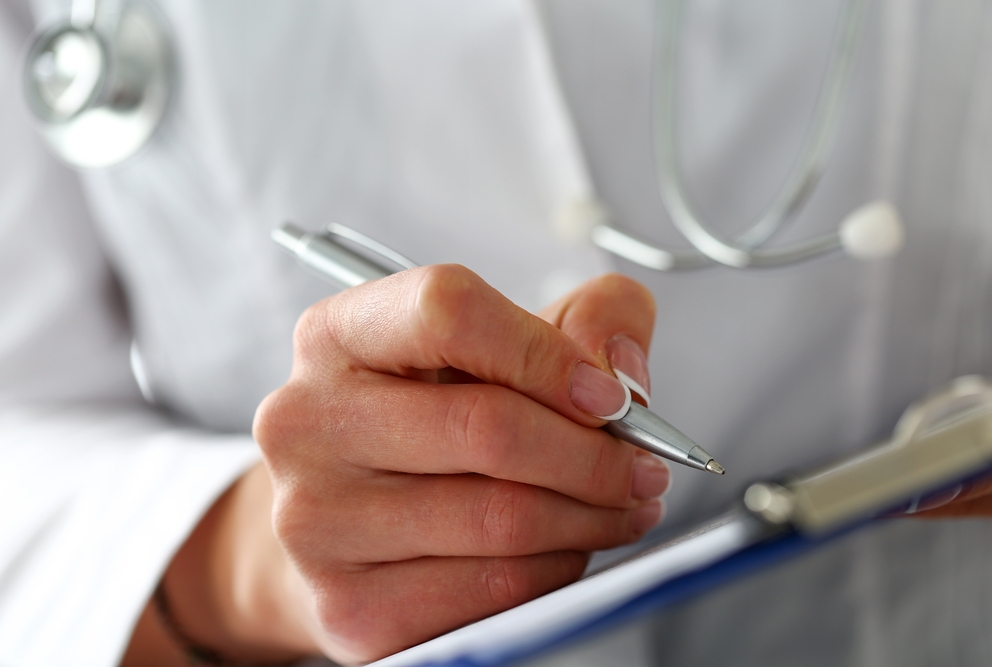 Female doctor holding clipboard pad
